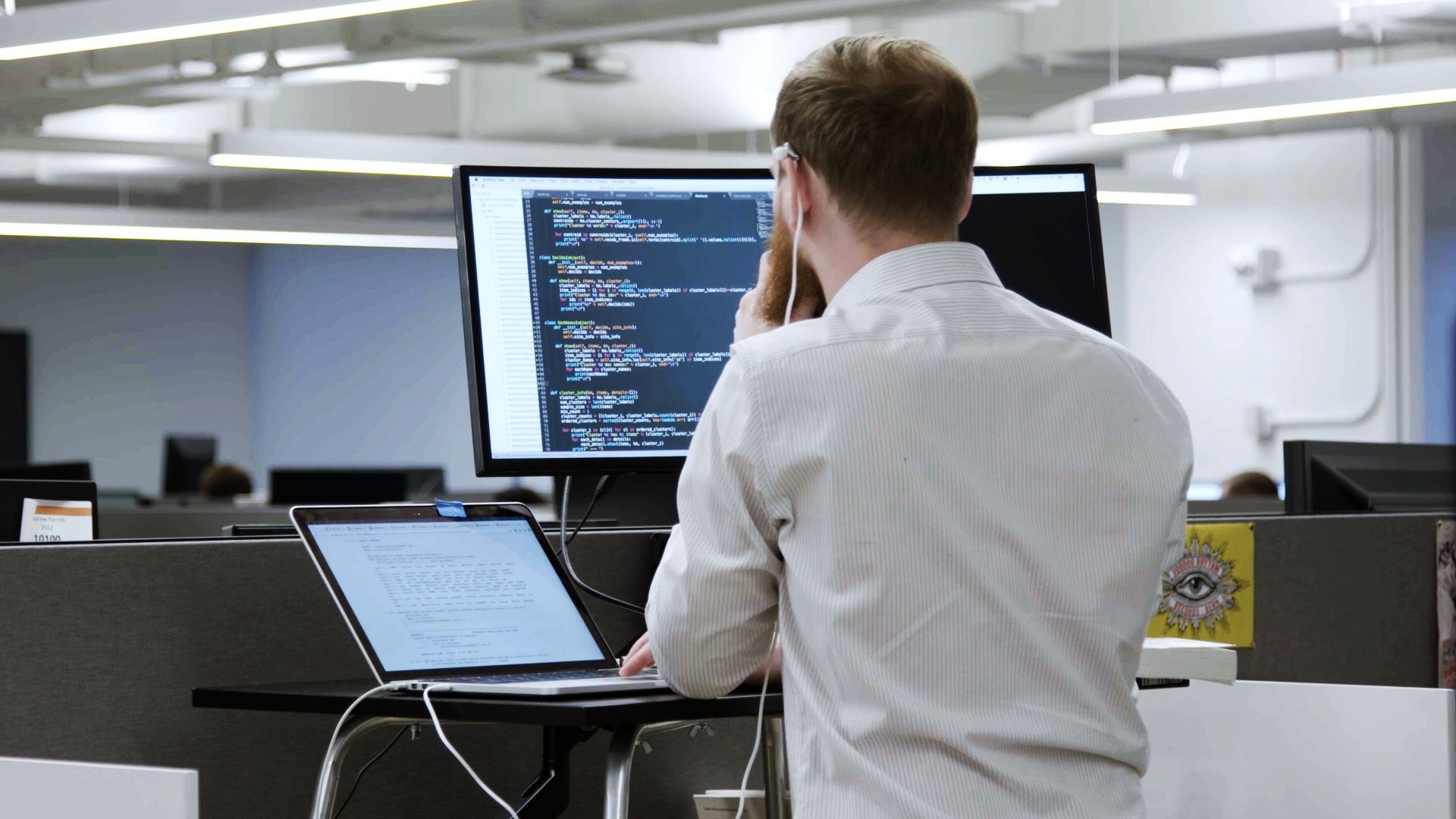 Man codes on at his stand up desk