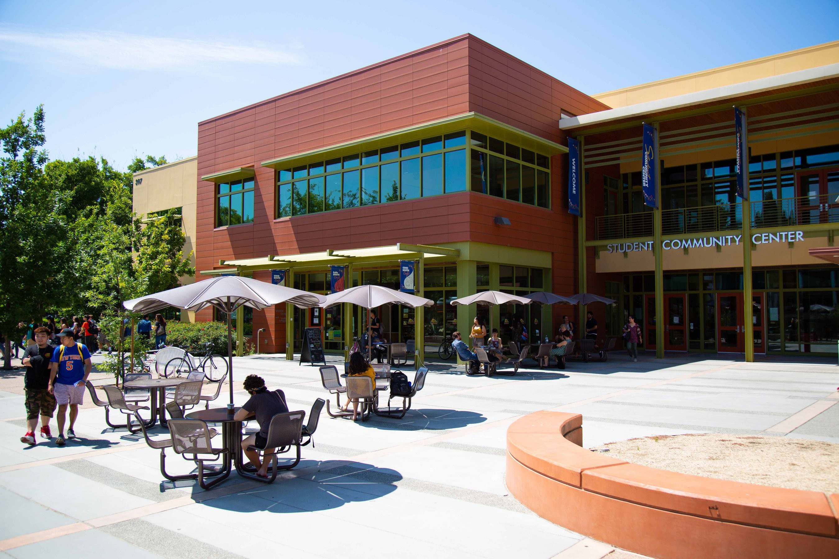 UC Davis students outside of the Student Community Center on a sunny day