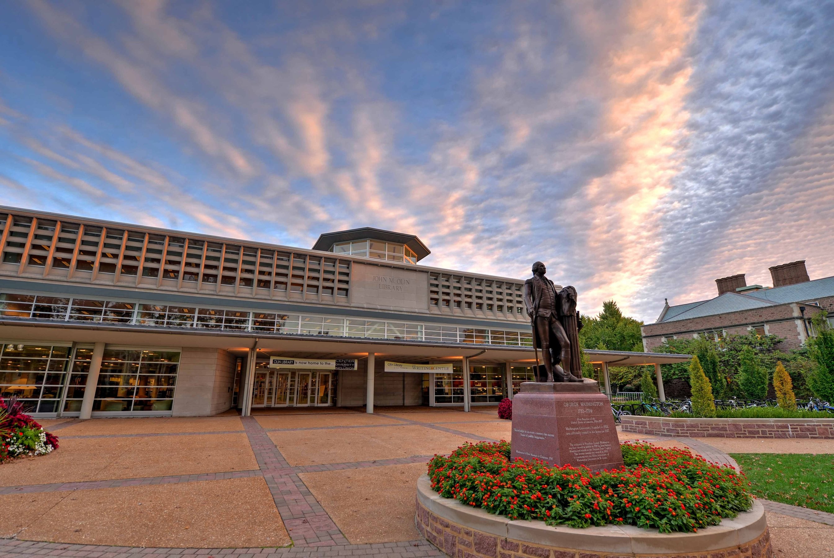 Cirrus clouds reflecting sunlight over the John M. Olin library on the Washington University in St. Louis campus