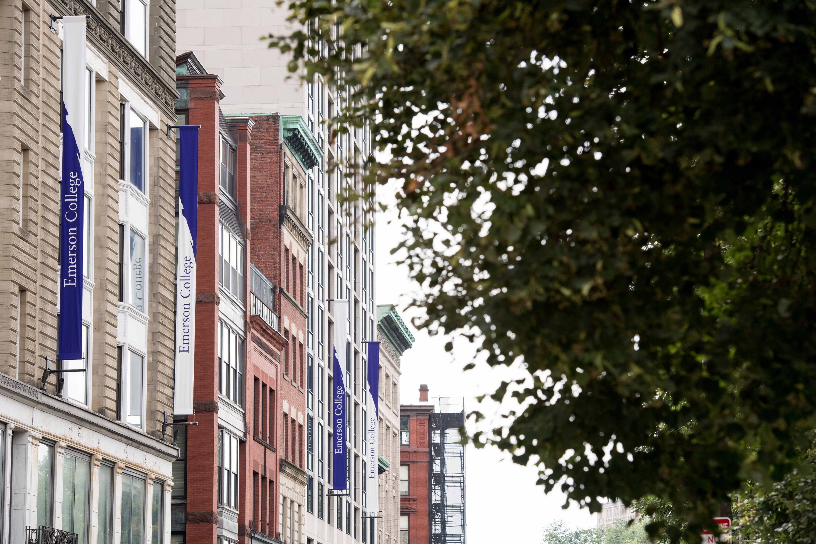 School banners hung vertically along the sides of academic buildings at Emerson College