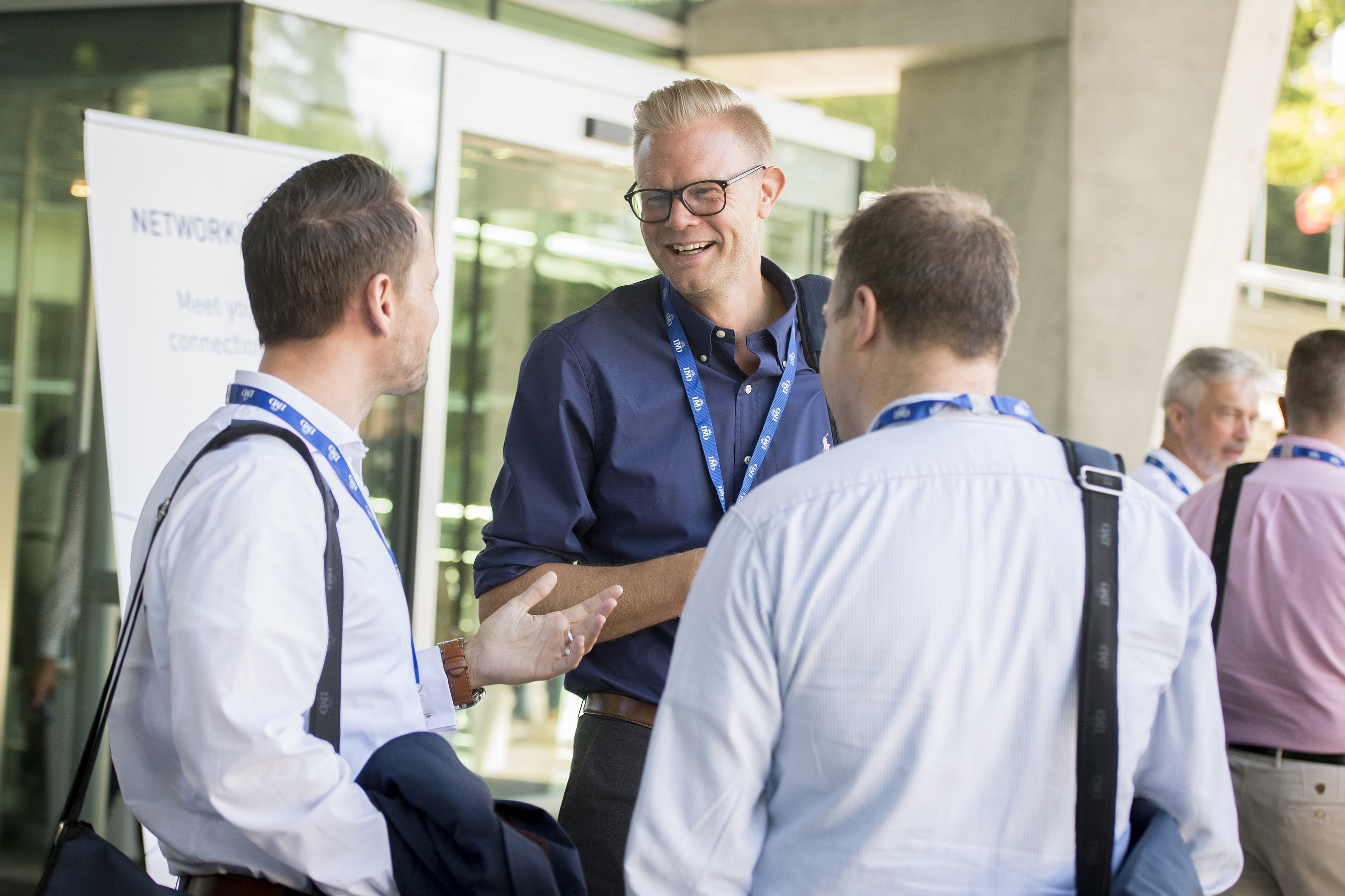 Three IMD students talking to one another