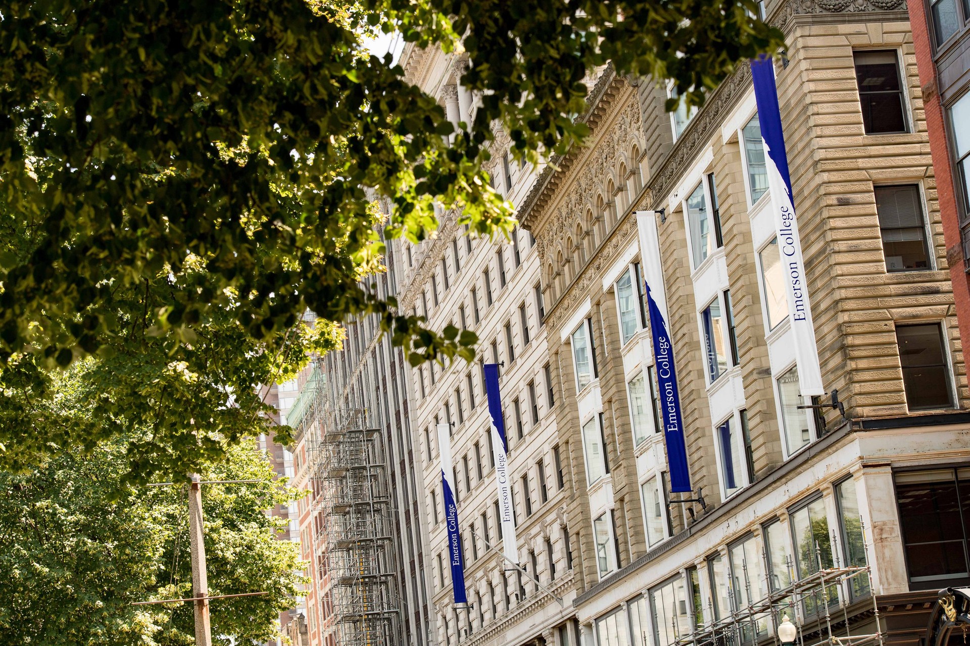 School banners line a walkway next to buildings on the Emerson College campus