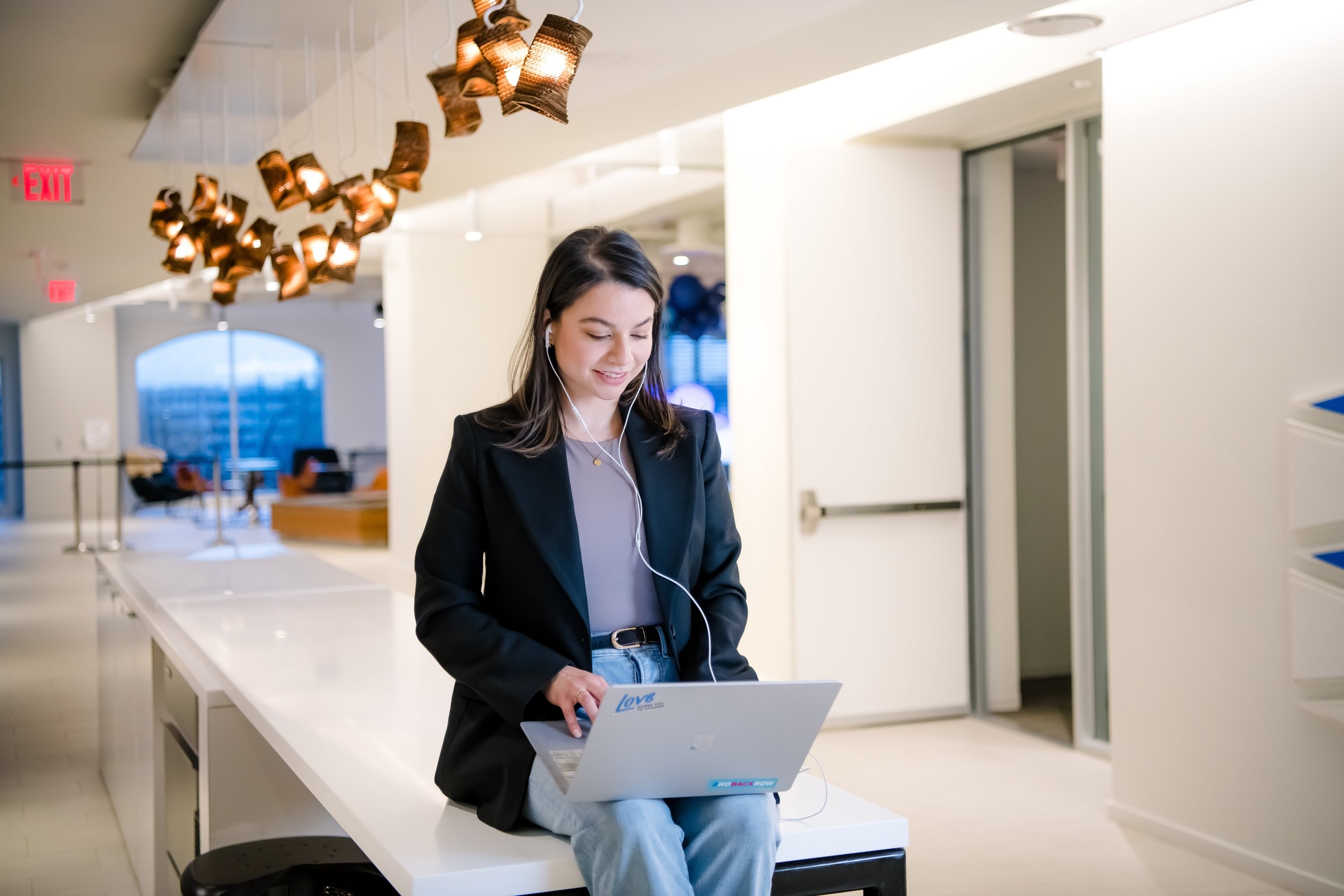 A woman works on her laptop.