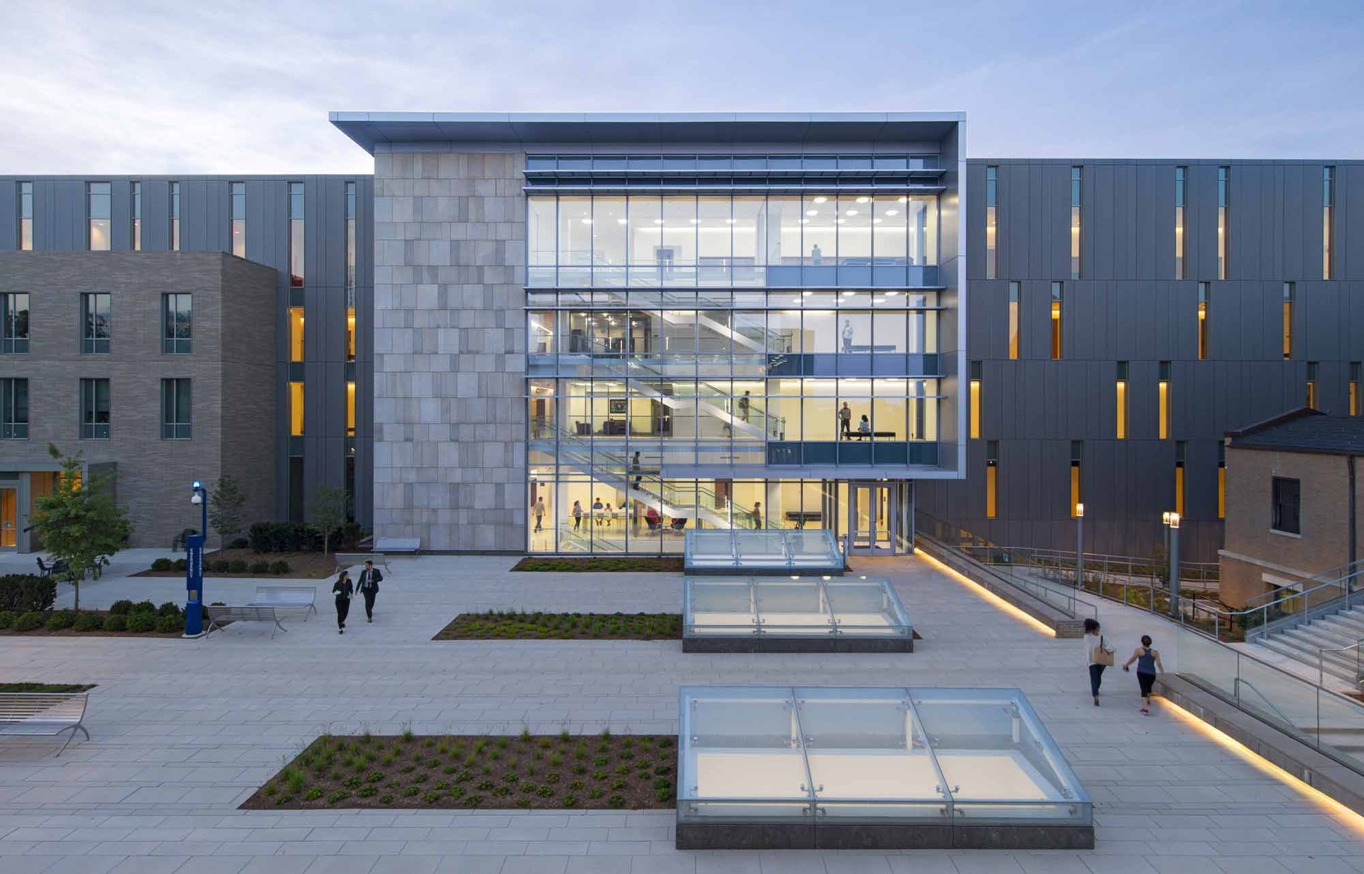 Students walking in the courtyard outside Yuma Hall at American University College of Law